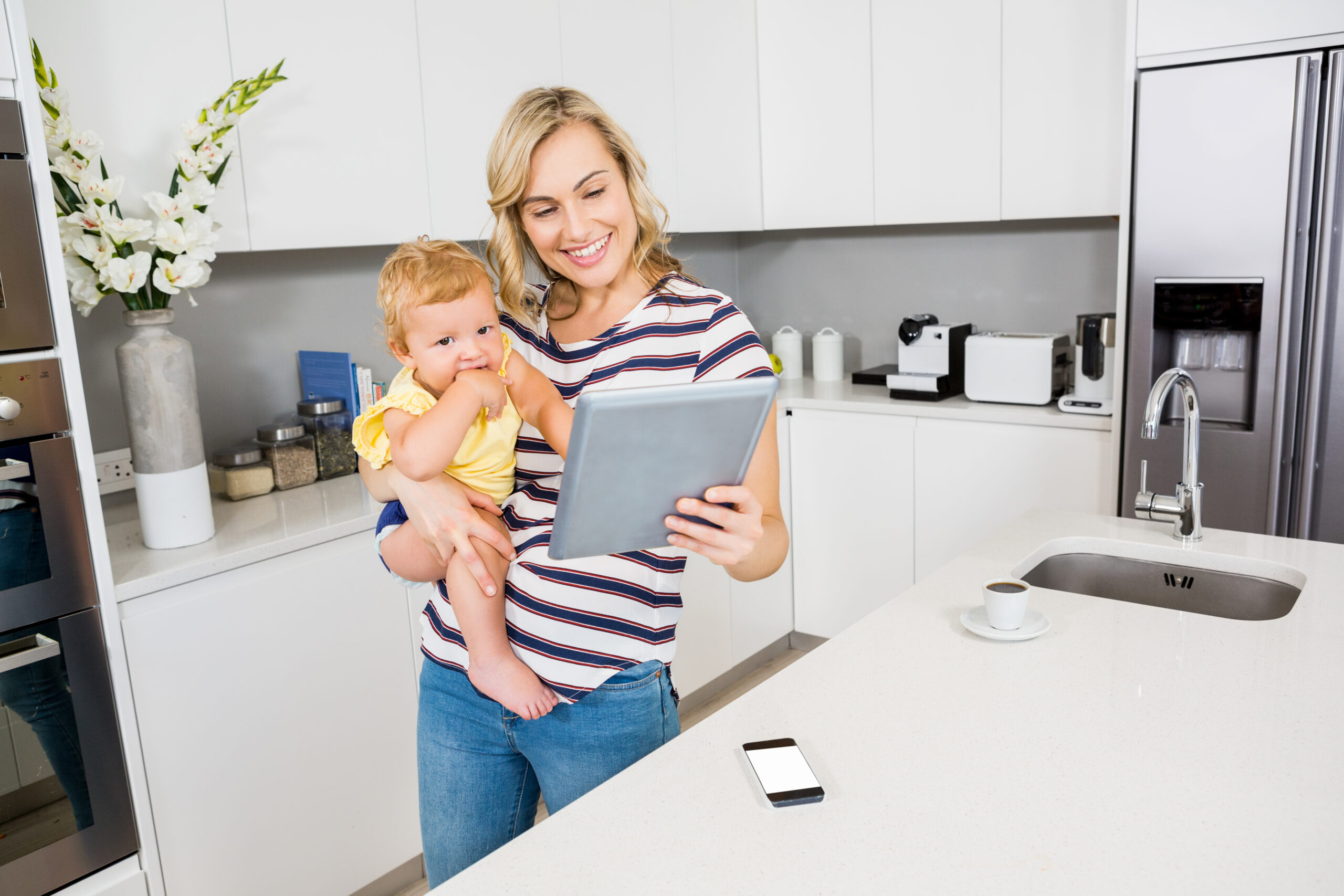 Mother and baby using a tablet together at home